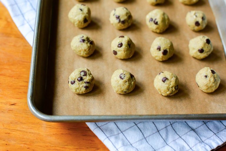 mini cookie dough balls on a cookie sheet