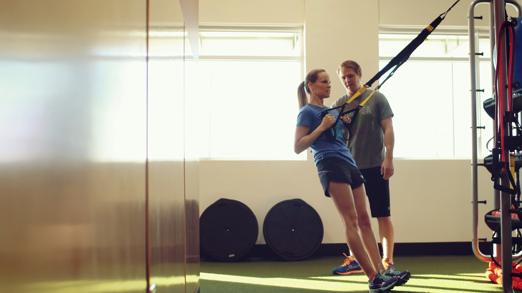 Fitness Woman Workout on TRX Straps in Gym. Crossfit Style