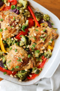 Photo of one pan crispy peanut chicken thighs in a serving dish