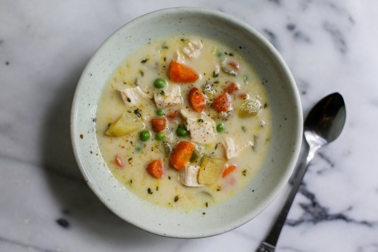 Bowl of chicken pot pie soup with spoon