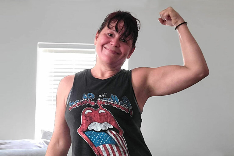 Christy flexing her bicep.