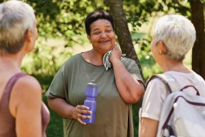 Middle-aged women chatting after going on a walk outside.