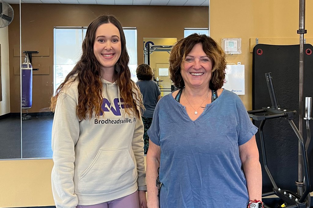 Sandra and her trainer, Rebecca, smiling at Anytime Fitness Brodheadsville.