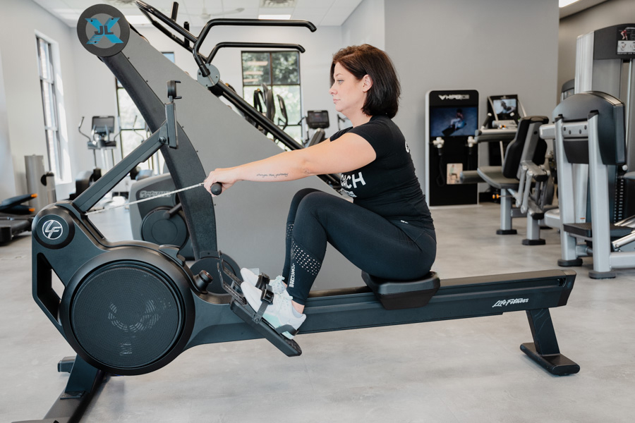 Coach Heather demonstrating the catch on a rowing machine