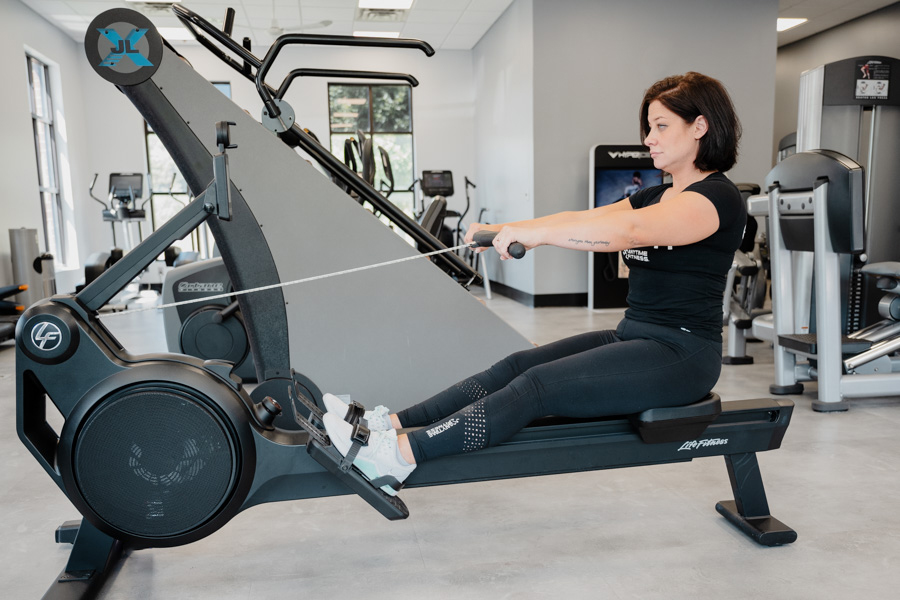 Coach Heather demonstrating the drive on a rowing machine.