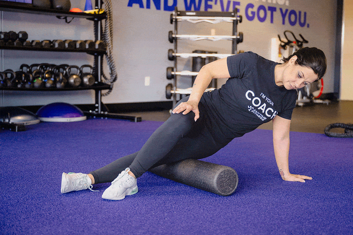 Coach Heather demonstrating foam rolling for IT band stretching.