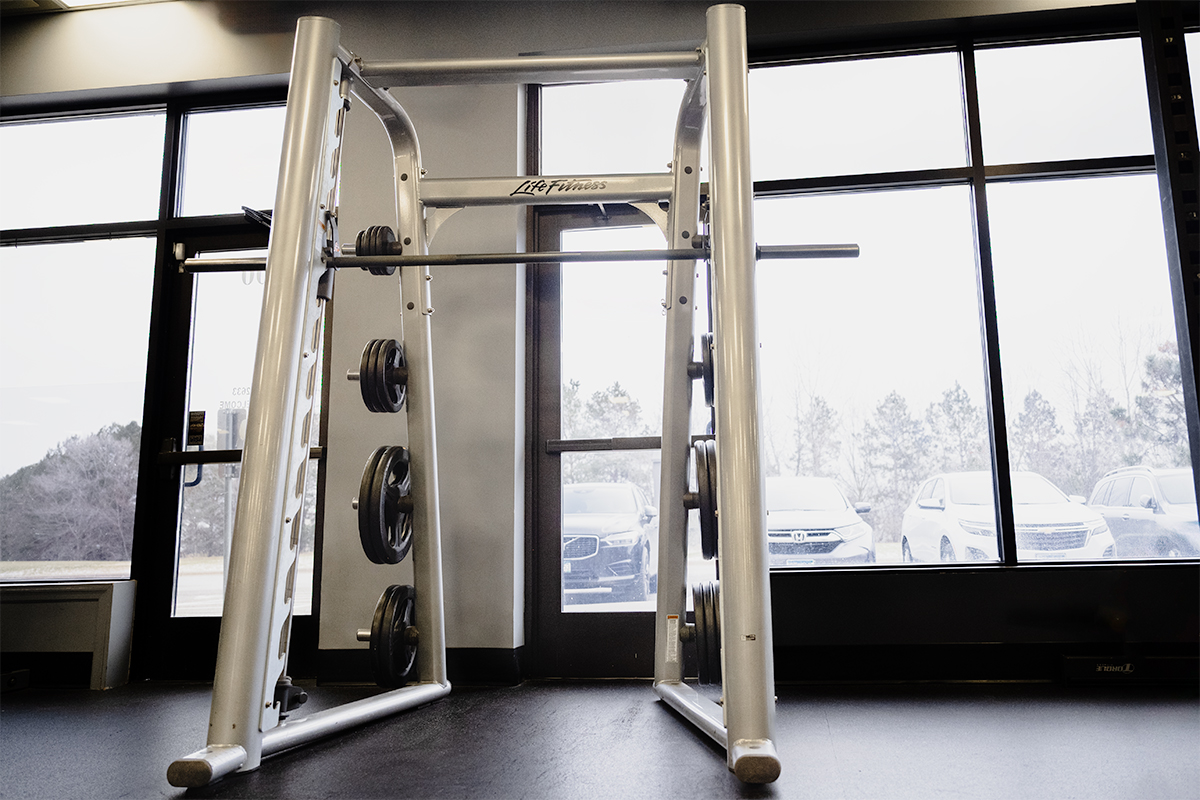 A Smith machine in the strength training area of a gym.