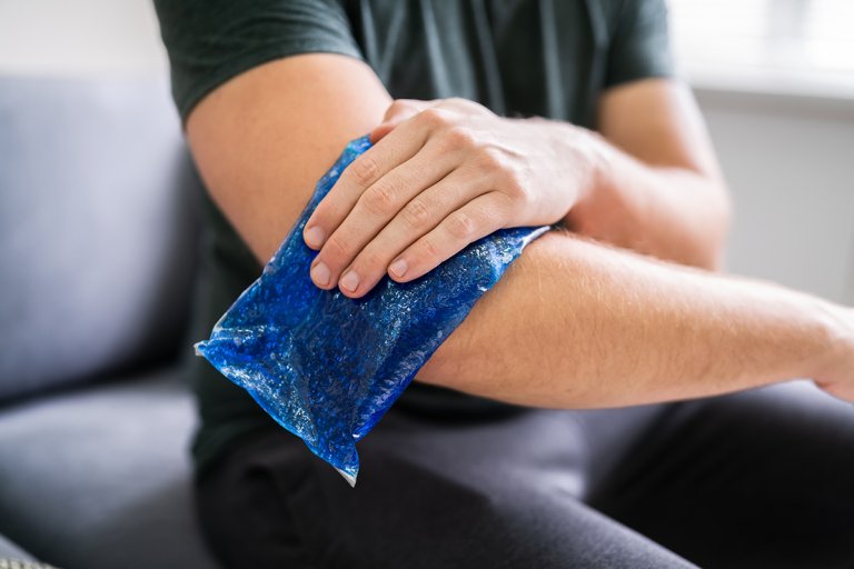 Man using ice gel pack while healing an injured arm.