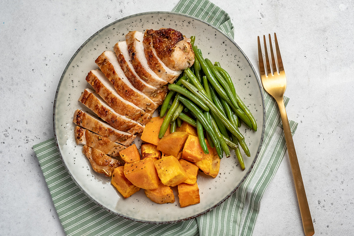 Grilled chicken breast, fillet with sweet potato or pumpkin and green beans, healthy food, top view.