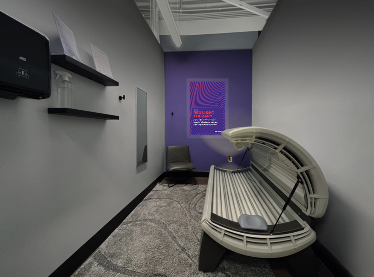 Red light therapy bed in a private room at an Anytime Fitness gym.