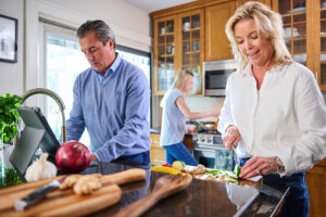 Family preparing a healthy meal together in the kitchen, showcasing teamwork and balanced cooking.