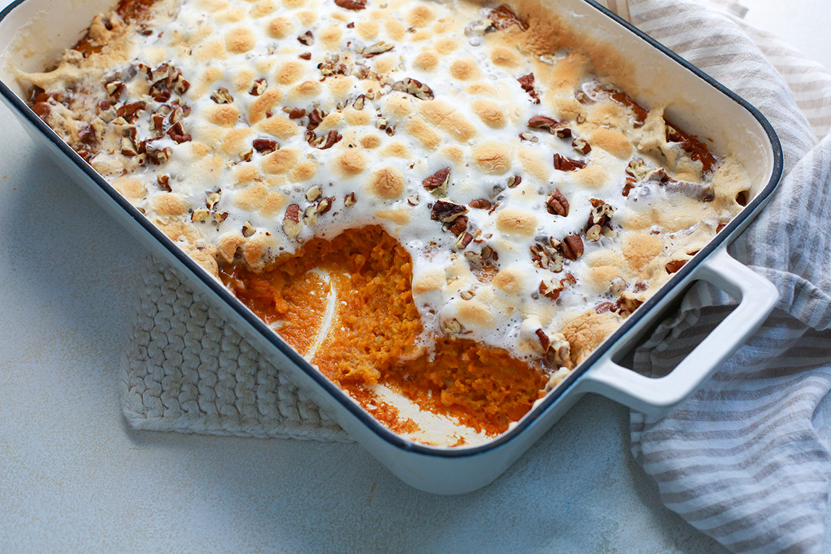 Homemade sweet potato casserole with marshmallows and pecans, a delicious and healthy holiday side dish.