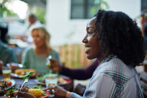 Woman eating a protein-packed meal in a group setting.